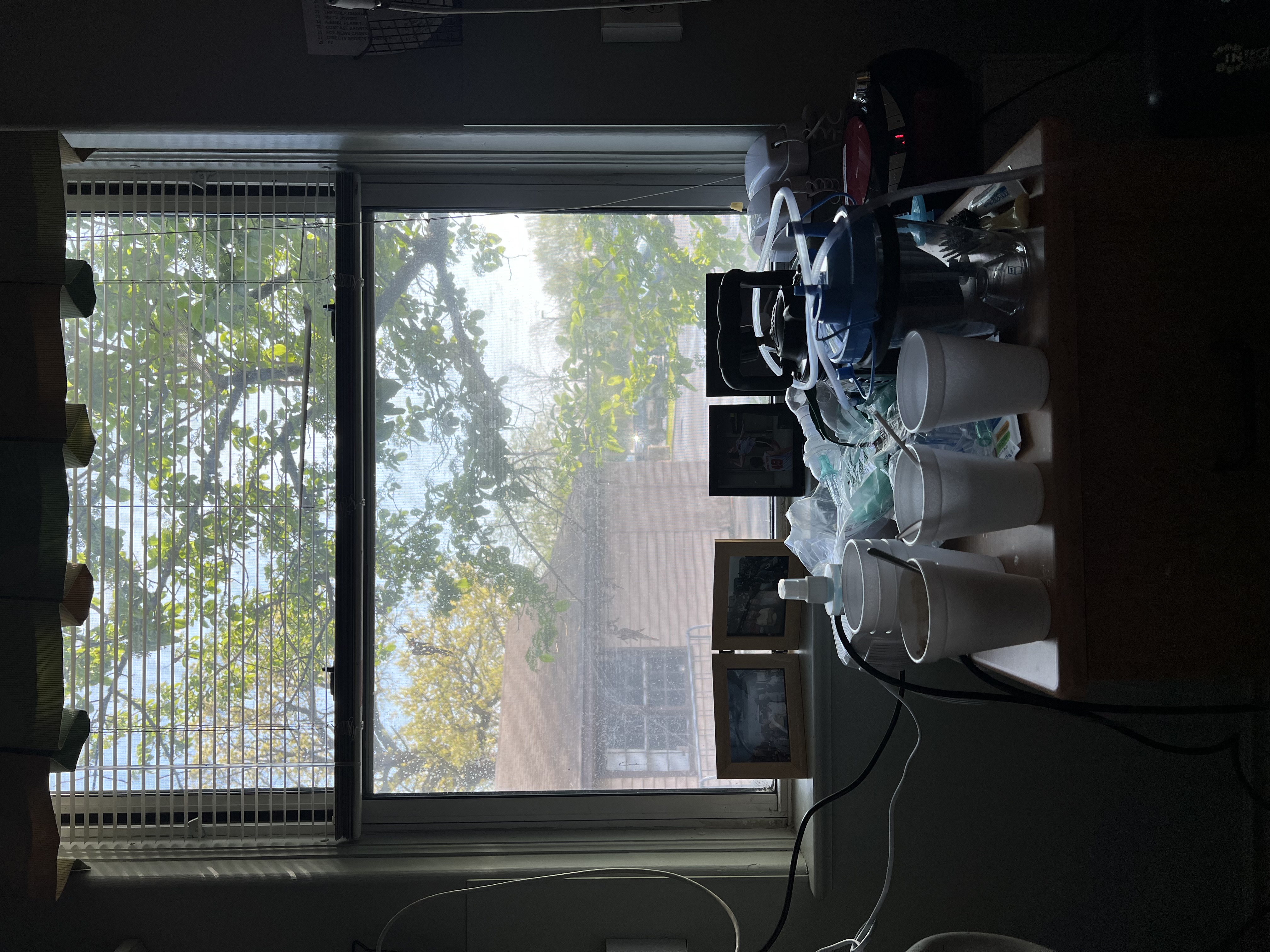 a view out a window with medical equipment in the foreground