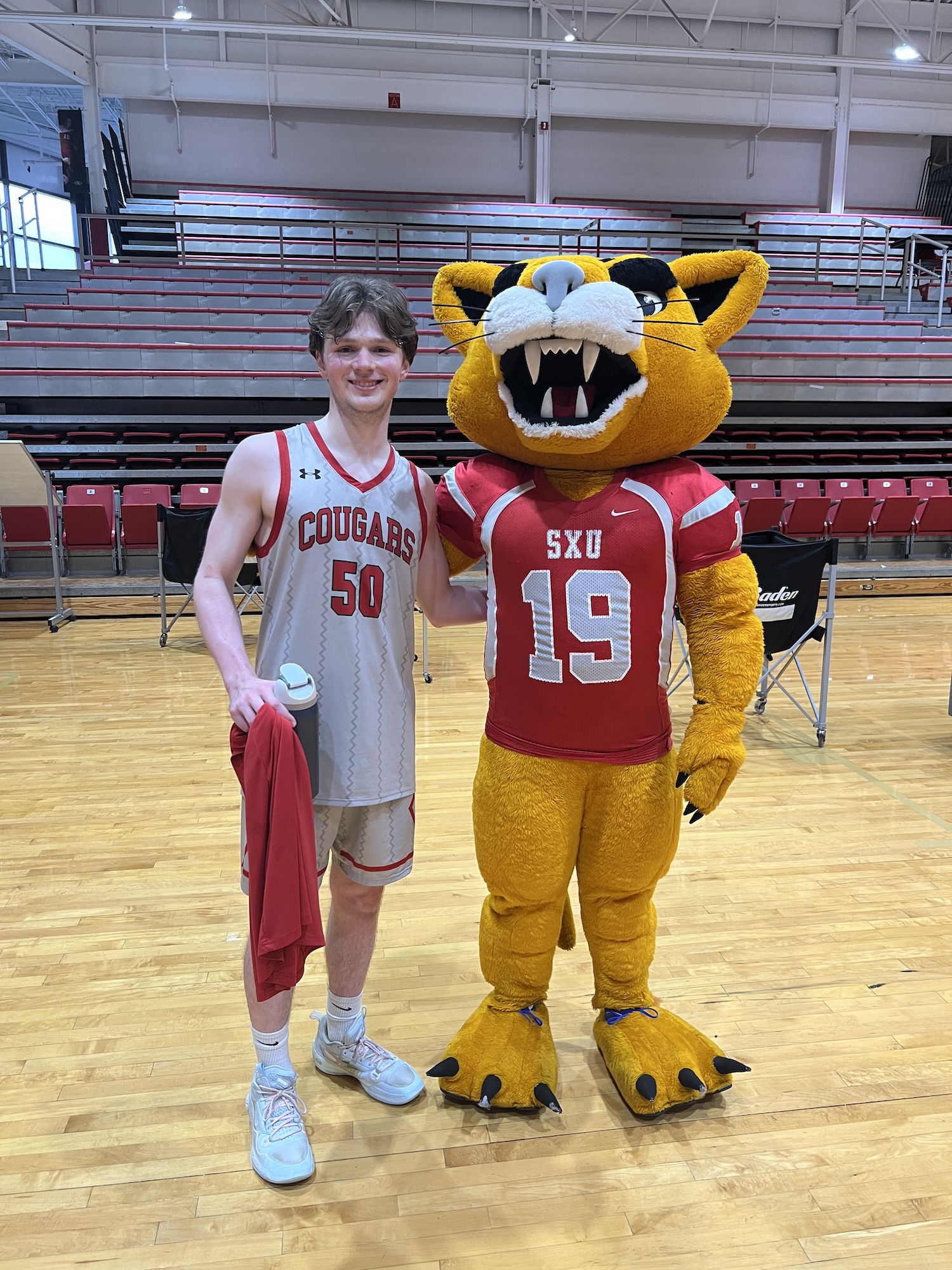 Danny poses with Champ, the SXU Cougars mascot